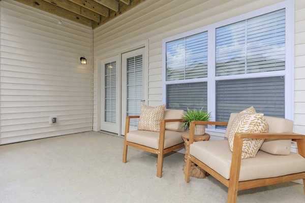 Cozy patio with seating area at The Lodges on English Station Rd Apartments