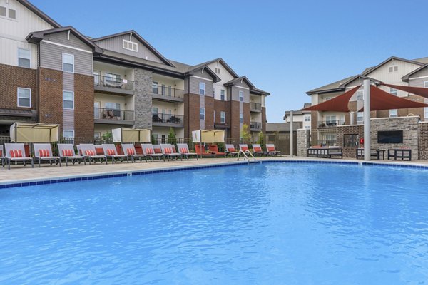 Resort-style pool with sleek lounge chairs at The Lodges on English Station Rd Apartments, ideal for relaxing