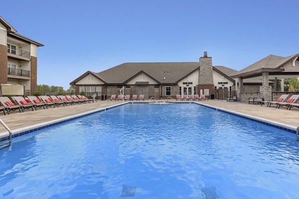 Inviting pool area with lounge chairs at The Lodges on English Station Rd Apartments, a luxury living community