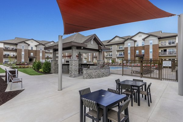 Cozy outdoor patio with seating at The Lodges on English Station Rd Apartments, perfect for relaxation and social gatherings
