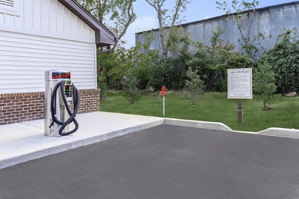 Covered car care station for vehicle maintenance at The Lodges on English Station Rd Apartments in a convenient location