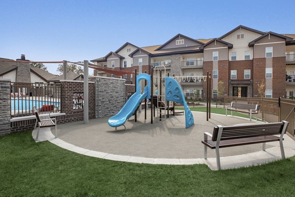Colorful children's playground at The Lodges on English Station Rd Apartments, offering fun outdoor activities for families