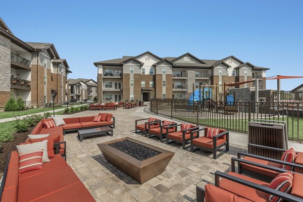 Cozy outdoor fire pit at The Lodges on English Station Rd Apartments, offering a relaxing and communal space for residents