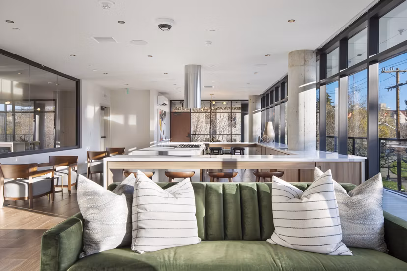 Modern clubhouse with plush seating at Connection on Broadway Apartments in a vibrant community setting