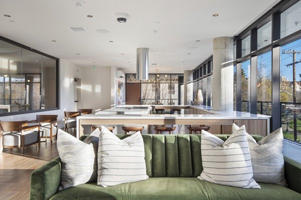 Modern clubhouse with plush seating at Connection on Broadway Apartments in a vibrant community setting