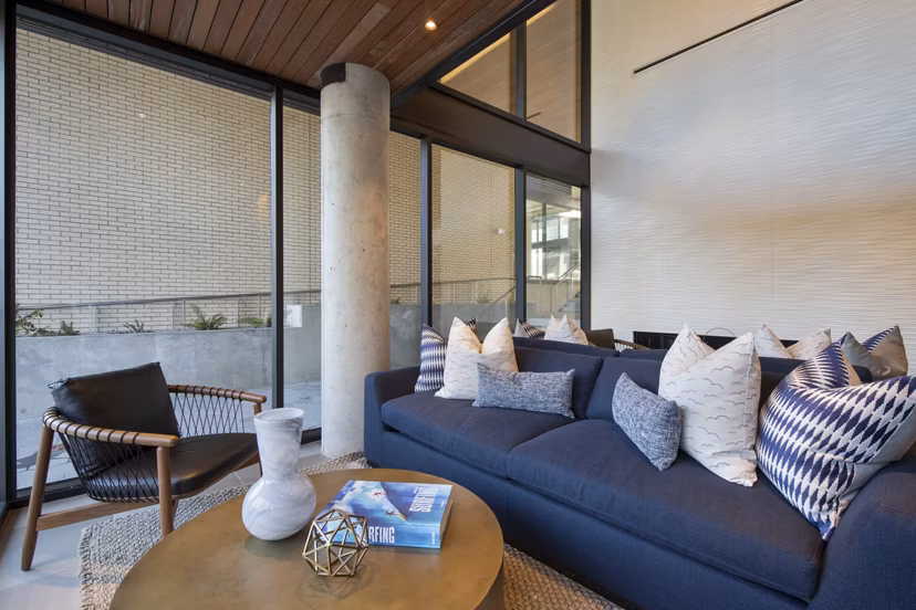 Modern clubhouse with plush seating and billiards table at Connection on Broadway Apartments
