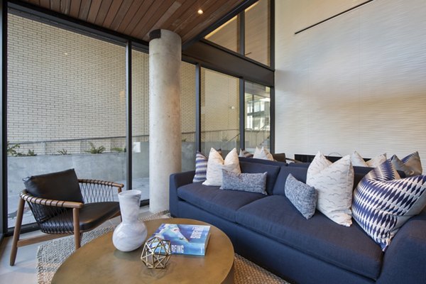 Modern clubhouse with plush seating and billiards table at Connection on Broadway Apartments