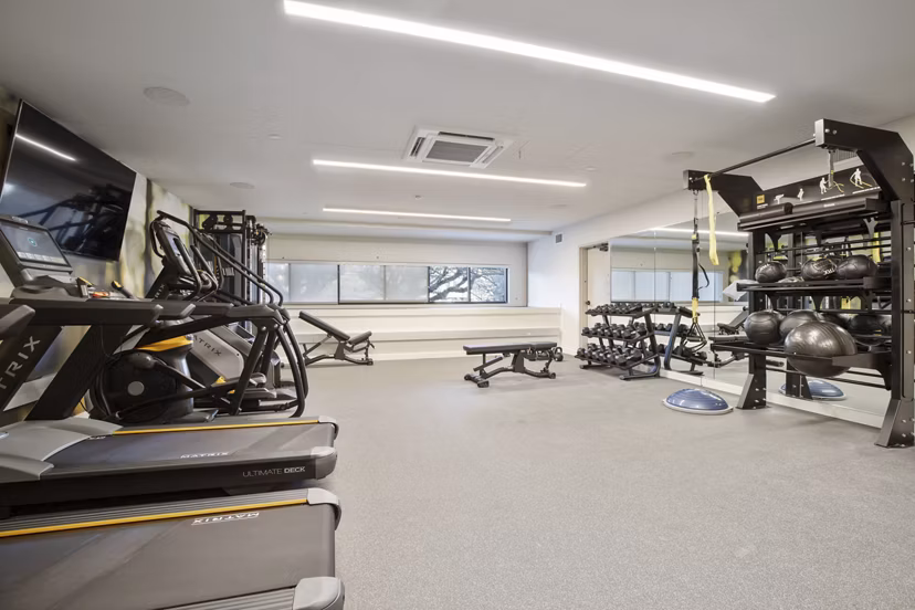 Well-equipped fitness center with modern machines at Capitol Hill Station Apartments in Seattle