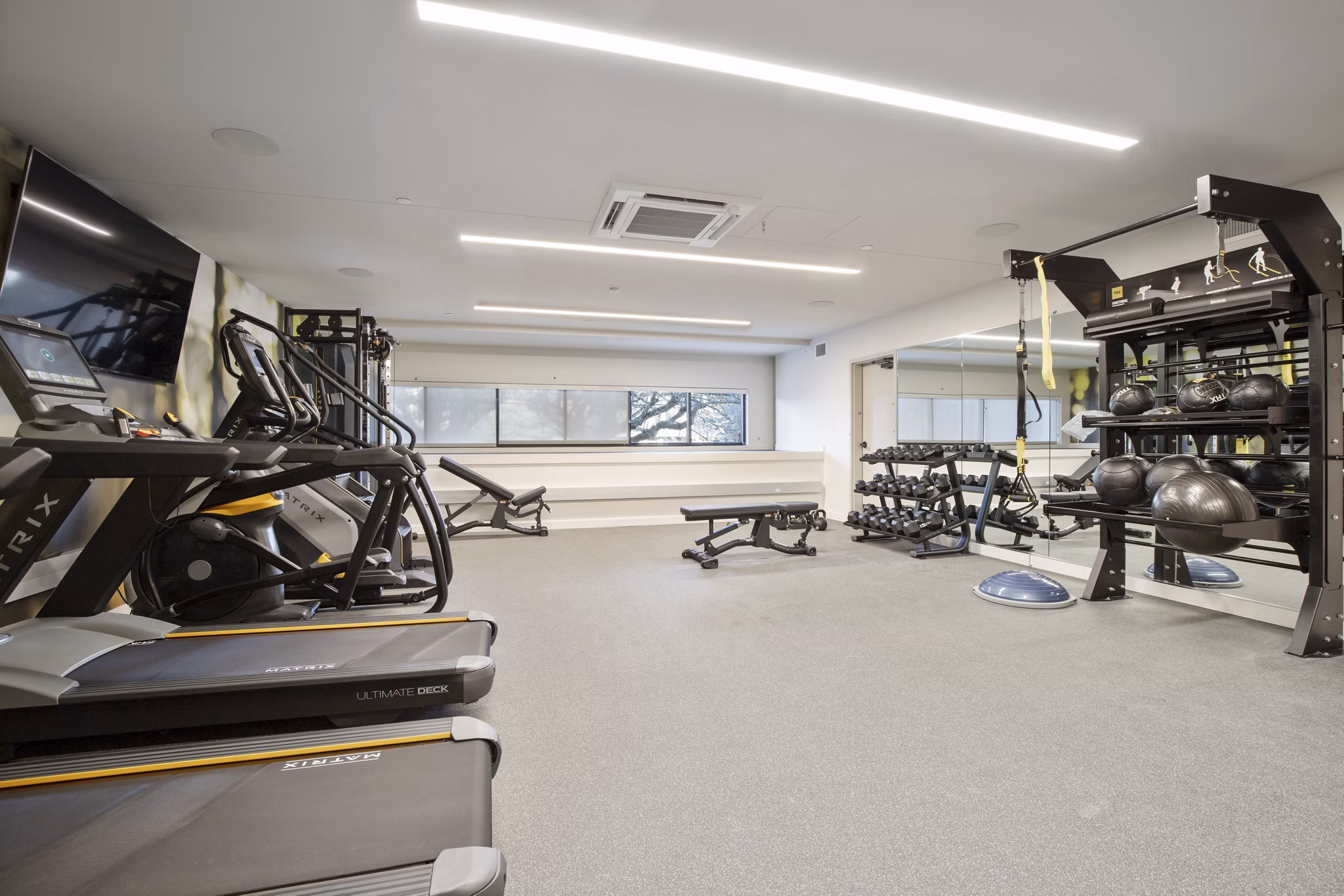 Well-equipped fitness center with modern machines at Capitol Hill Station Apartments in Seattle