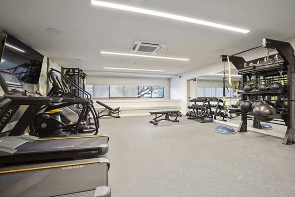 Well-equipped fitness center with modern machines at Capitol Hill Station Apartments in Seattle