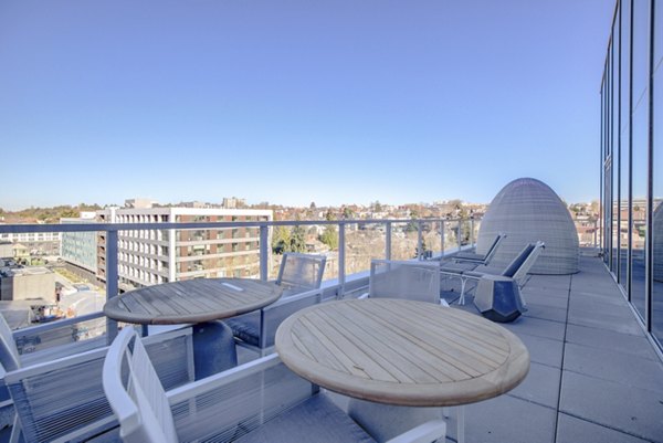 Outdoor patio with stylish seating at Capitol Hill Station Apartments, perfect for relaxation and social gatherings in a vibrant urban setting