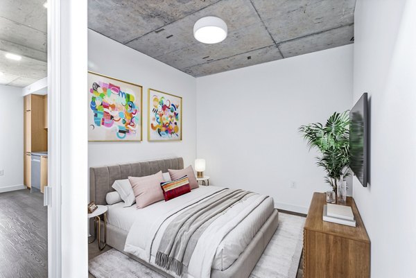 Cozy bedroom with modern decor at Connection on Broadway Apartments