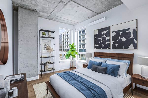 Spacious bedroom with modern decor at Connection on Broadway Apartments, showcasing luxury living in a prime location