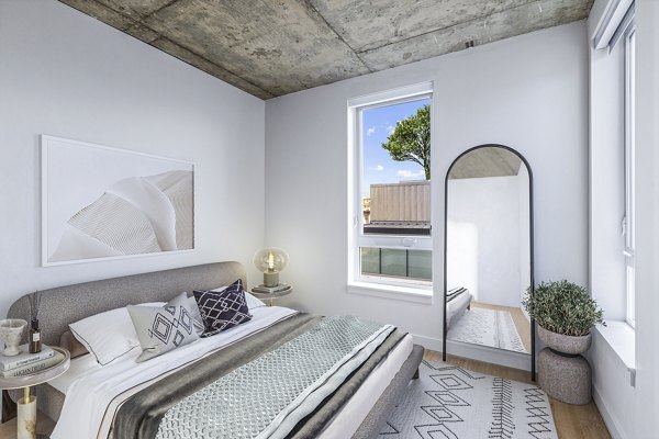Cozy bedroom with modern design elements at Connection on Broadway Apartments