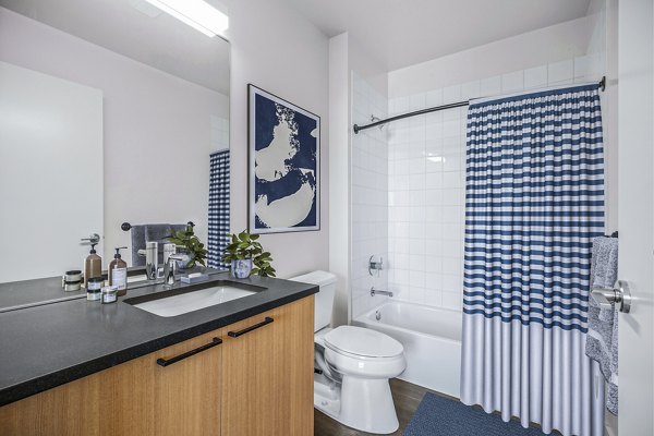 Bathroom featuring modern fixtures and sleek design at Connection on Broadway Apartments