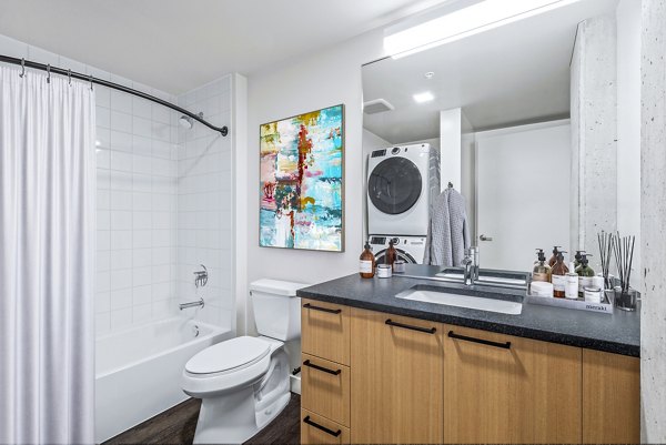 Elegant bathroom featuring modern fixtures and ample natural light at Connection on Broadway Apartments
