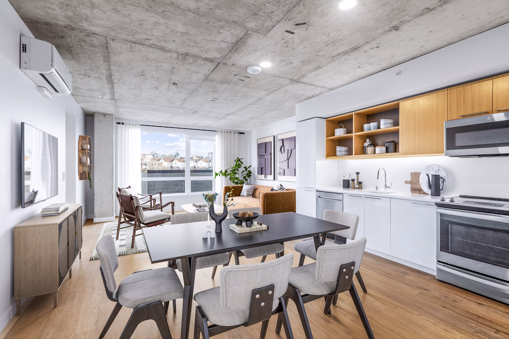 Modern kitchen featuring stainless steel appliances and quartz countertops at Connection on Broadway Apartments