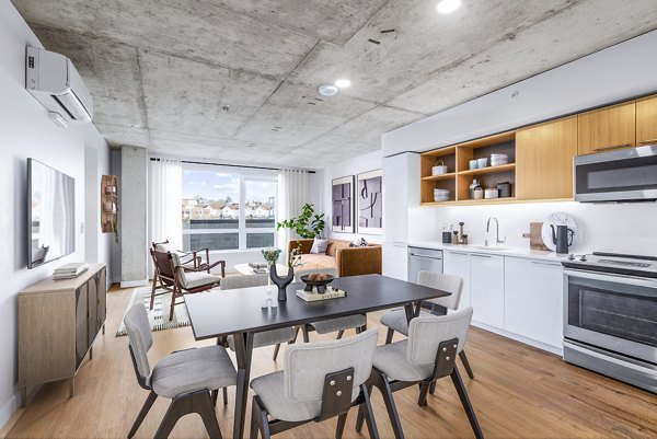 Modern kitchen featuring stainless steel appliances and quartz countertops at Connection on Broadway Apartments