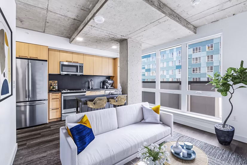 Sleek kitchen with stainless steel appliances at Connection on Broadway Apartments luxury units