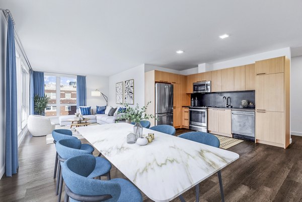 Dining area with modern decor and large windows at Connection on Broadway Apartments in a luxury setting