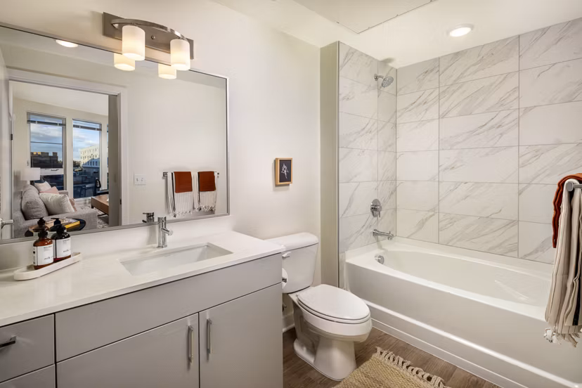 Modern bathroom with elegant fixtures at Revel Apartments, showcasing luxury apartment living in style and comfort