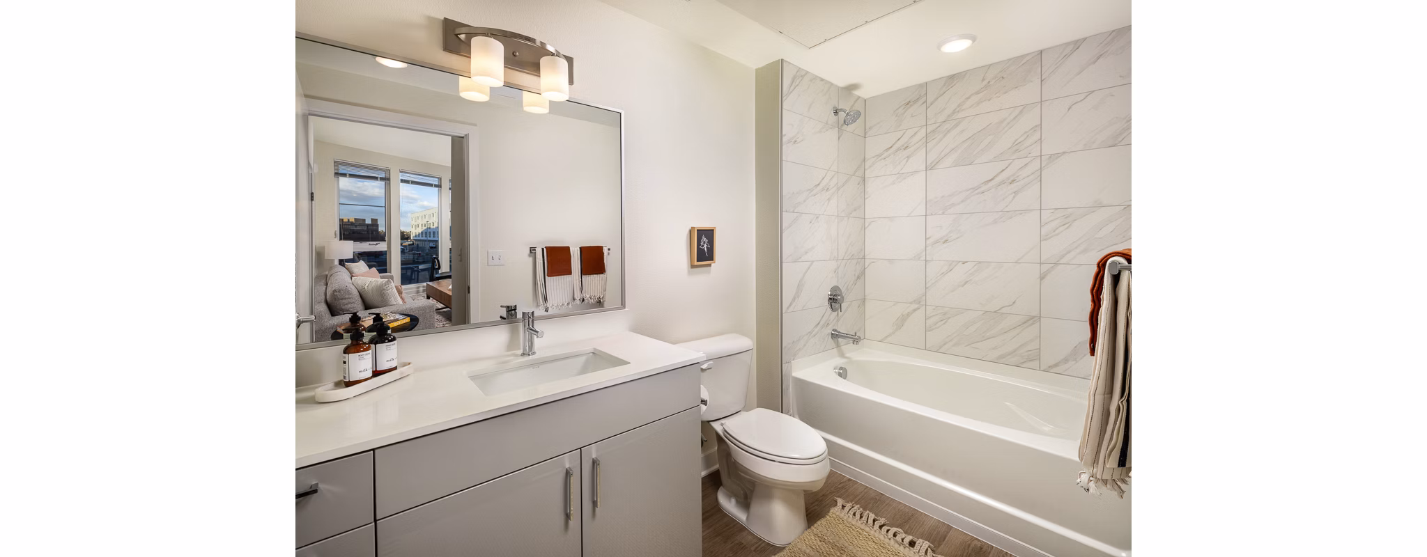 Modern bathroom with elegant fixtures at Revel Apartments, showcasing luxury apartment living in style and comfort
