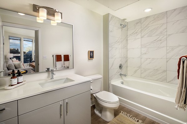 Modern bathroom with elegant fixtures at Revel Apartments, showcasing luxury apartment living in style and comfort