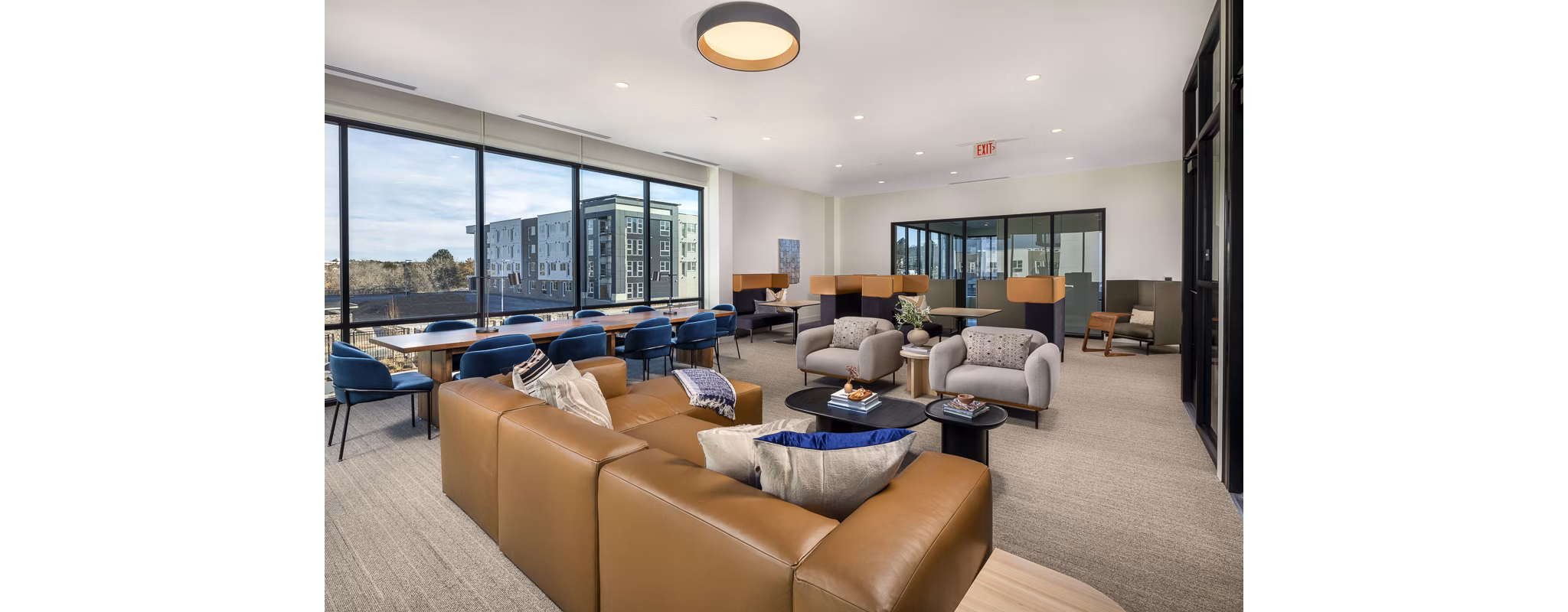 Stylish clubhouse featuring modern decor and seating at Revel Apartments