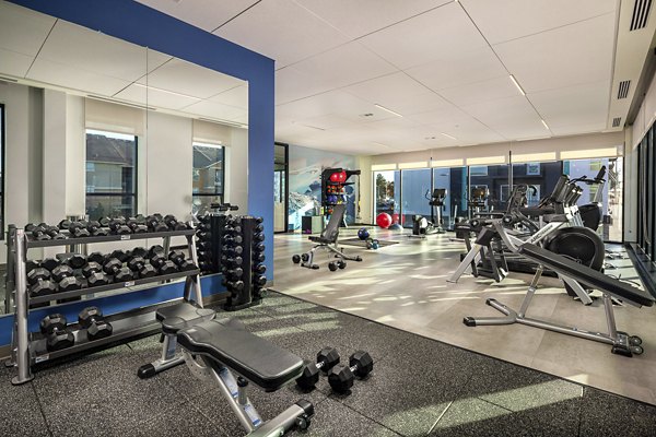 Well-equipped fitness center with modern machines at Revel Apartments, a Greystar community focused on luxury and comfort