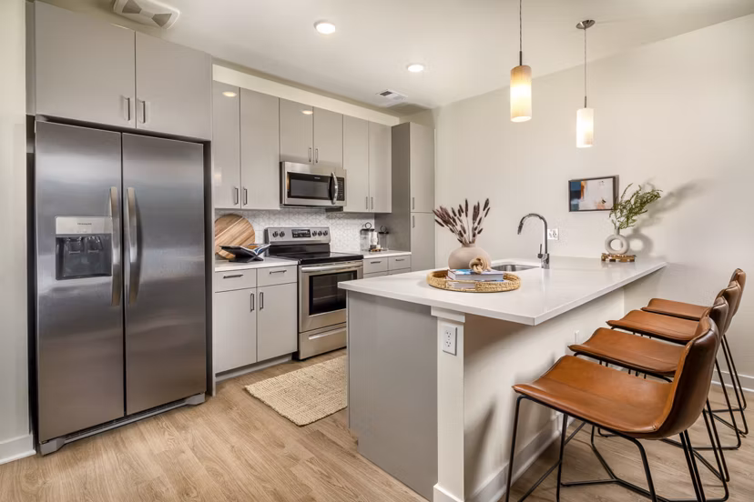Modern kitchen with stainless steel appliances at Revel Apartments