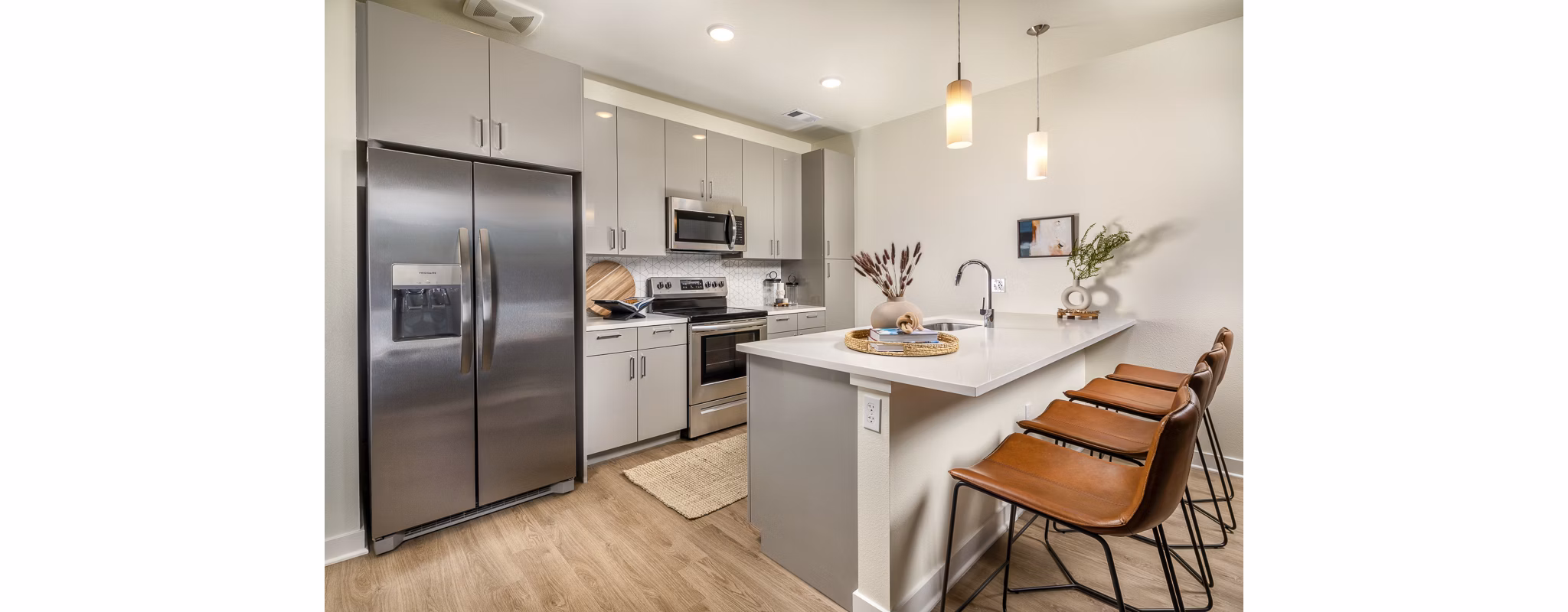 Modern kitchen with stainless steel appliances at Revel Apartments