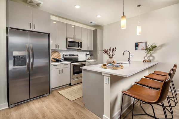 Modern kitchen with stainless steel appliances at Revel Apartments