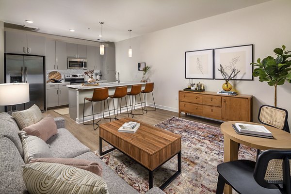 Spacious living room with modern furnishings at Revel Apartments, a luxury complex ideal for comfortable living moments