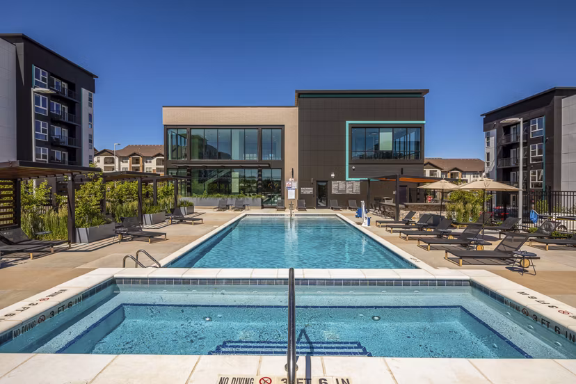 Rooftop pool offering cityscape views at Revel Apartments