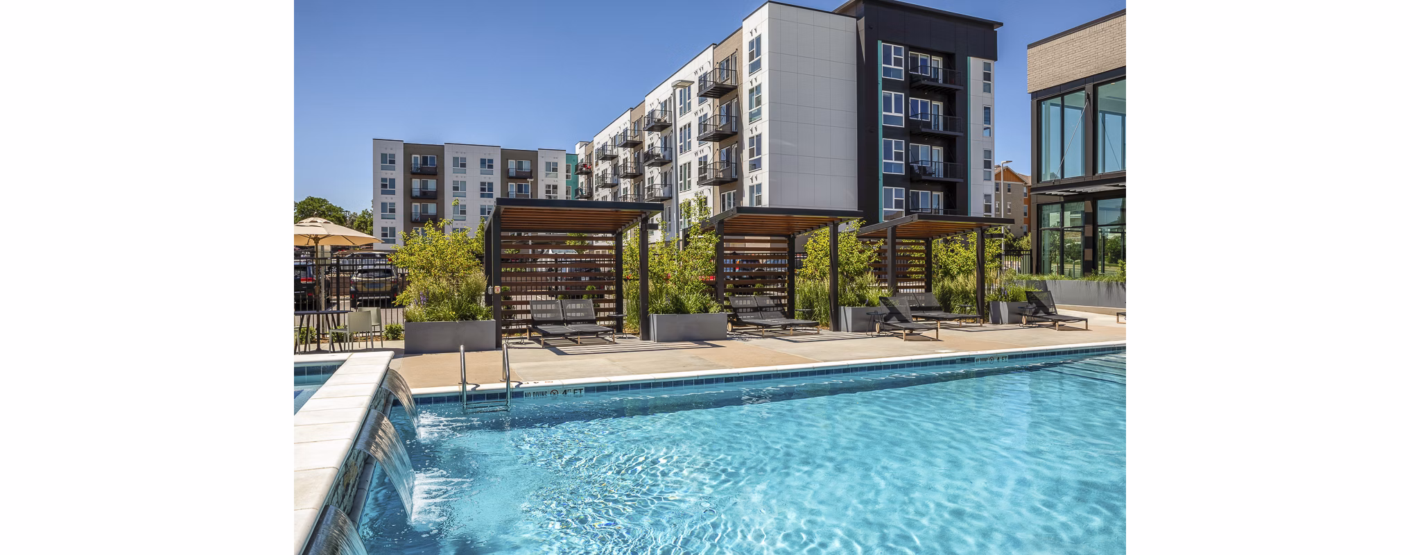 Sparkling pool at Revel Apartments offering luxury relaxation and recreation