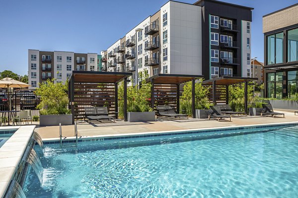 Sparkling pool at Revel Apartments offering luxury relaxation and recreation