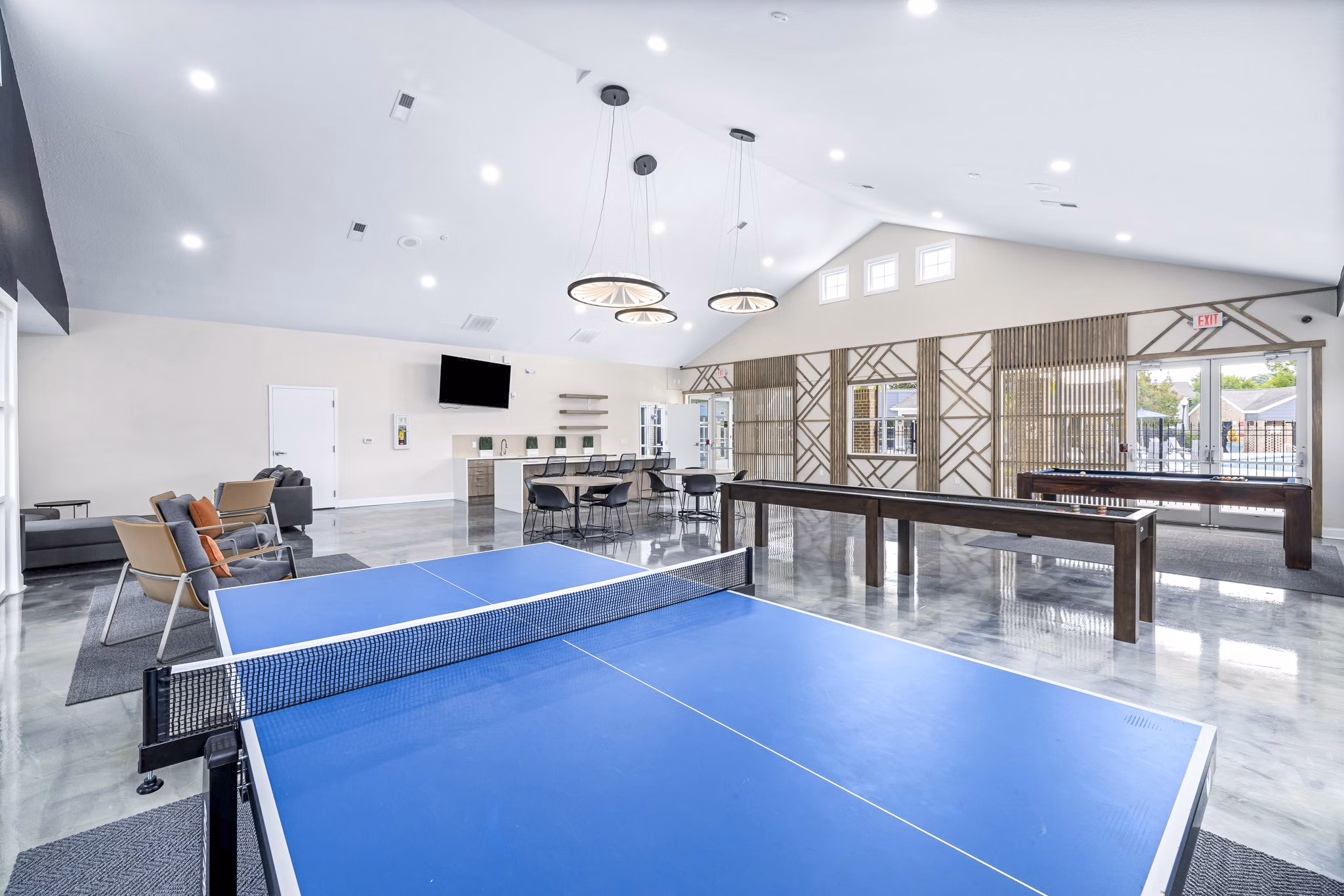 Clubhouse game room with billiards and lounge seating at 403 West Apartments, a Greystar luxury apartment community