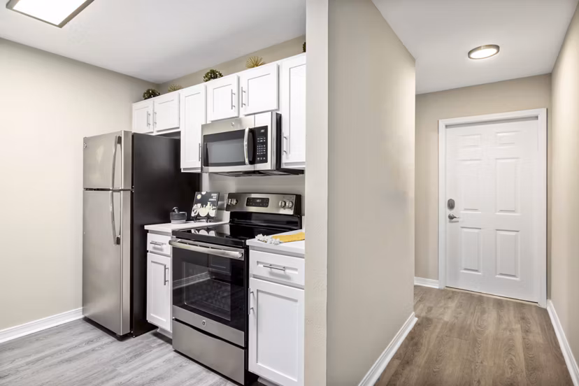 Modern kitchen featuring sleek countertops and stainless steel appliances at 403 West Apartments