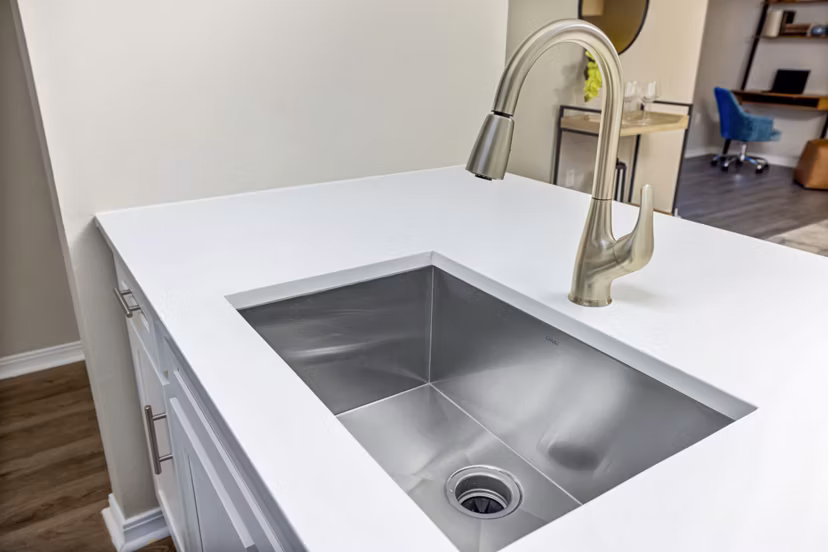 Modern kitchen with stainless steel appliances and granite countertops at 403 West Apartments
