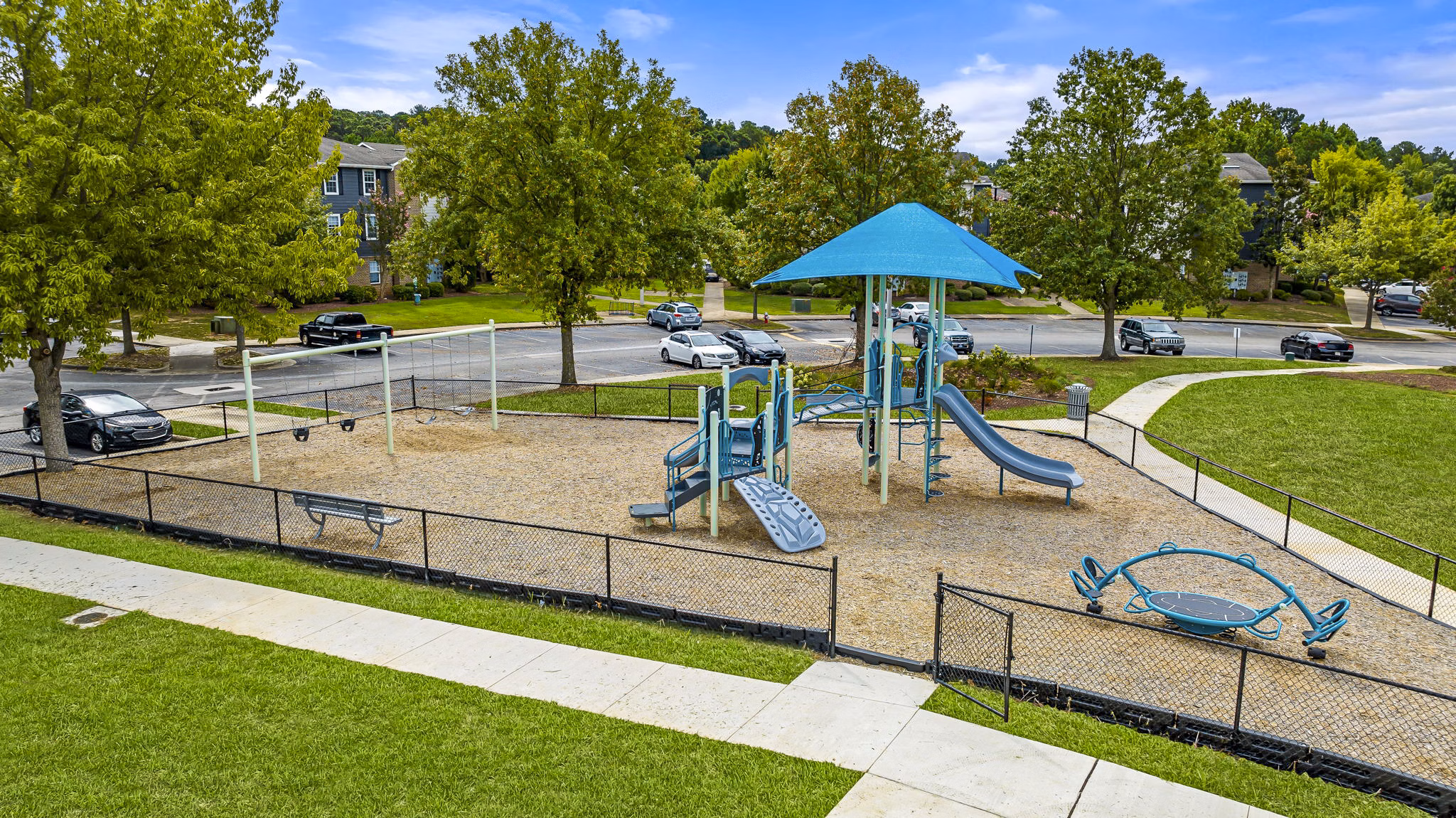 Playground featuring modern play equipment at 403 West Apartments, a luxury community for families to enjoy recreational activities