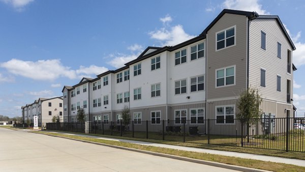 Luxury apartments with parked cars in front in a vibrant urban setting