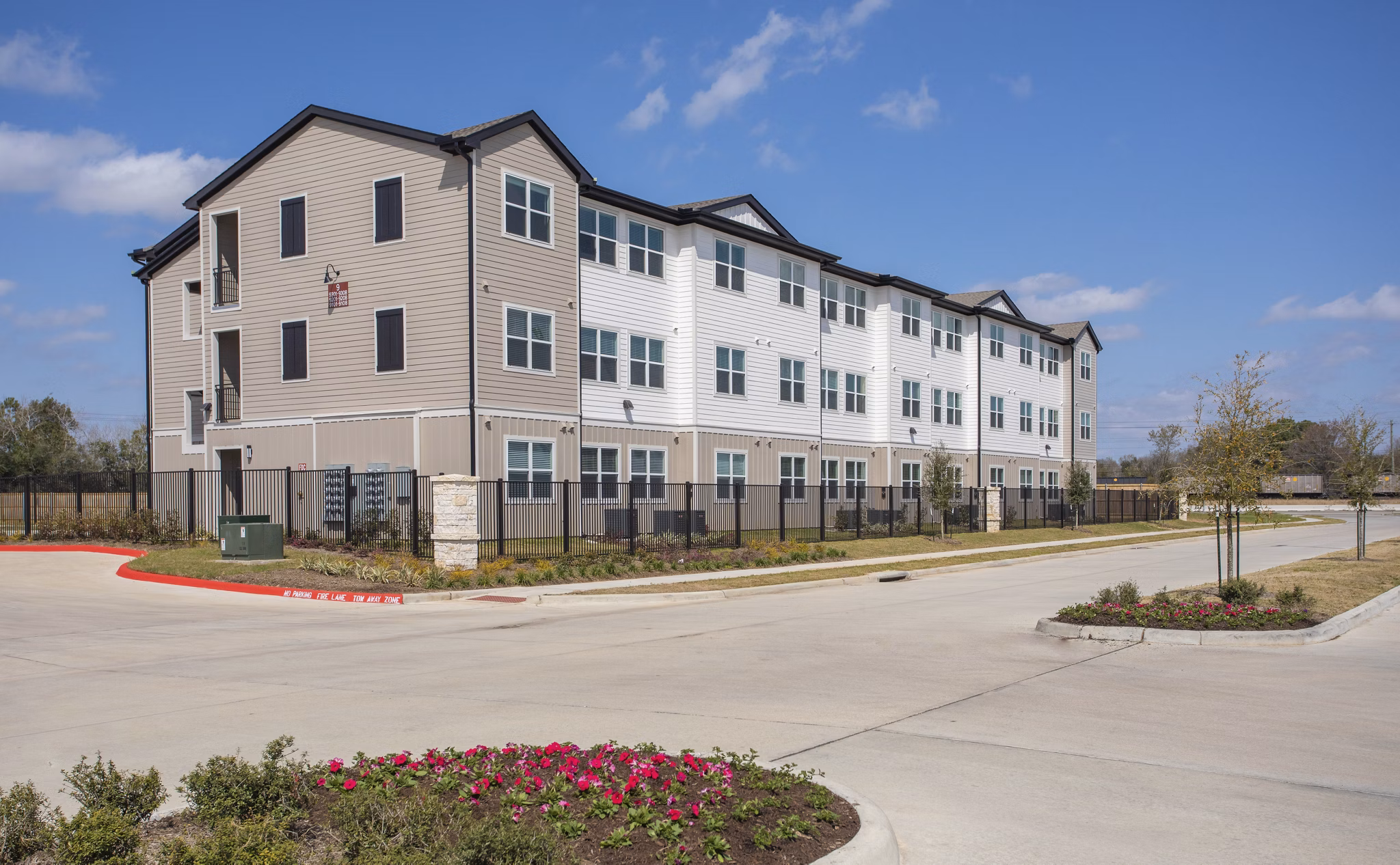 Luxury apartment building with landscaped grounds and parking in a vibrant community