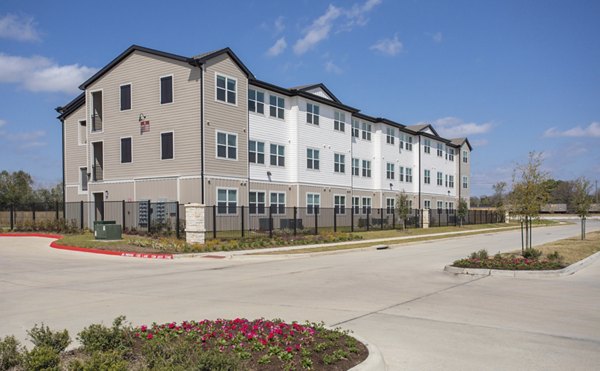 Luxury apartment building with landscaped grounds and parking in a vibrant community