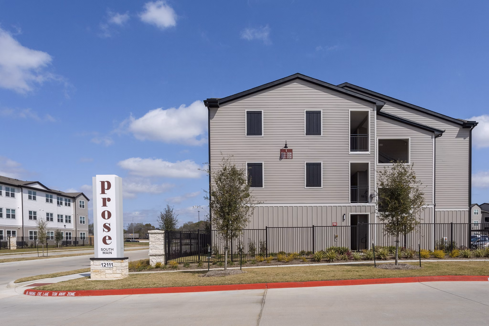 Prose: Contemporary apartment building with modern architecture and welcoming entrance