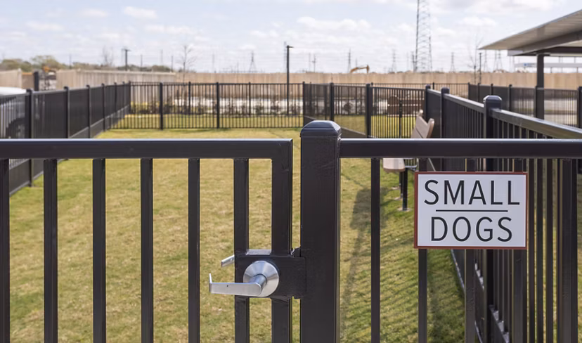 Fenced area for small dogs at luxury apartments, providing a safe space for pets to play
