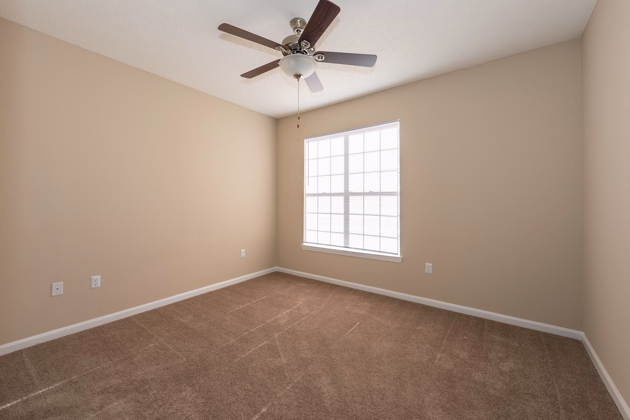 Cozy bedroom with natural light at Mainstreet at Conyers Apartments, featuring modern decor and spacious layout