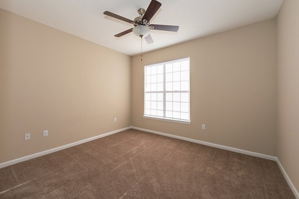 Cozy bedroom with natural light at Mainstreet at Conyers Apartments, featuring modern decor and spacious layout