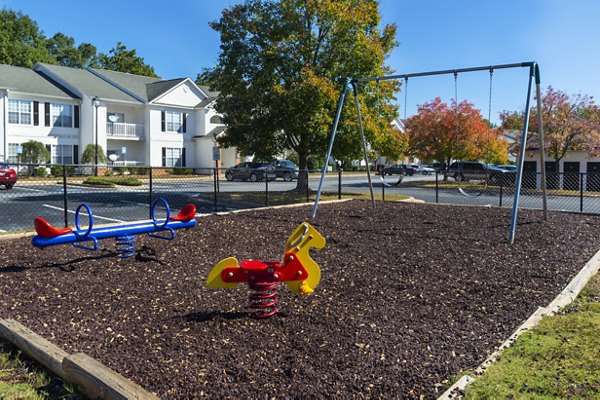 Playground at Mainstreet at Conyers Apartments featuring colorful slides and climbing structures for family-friendly outdoor fun