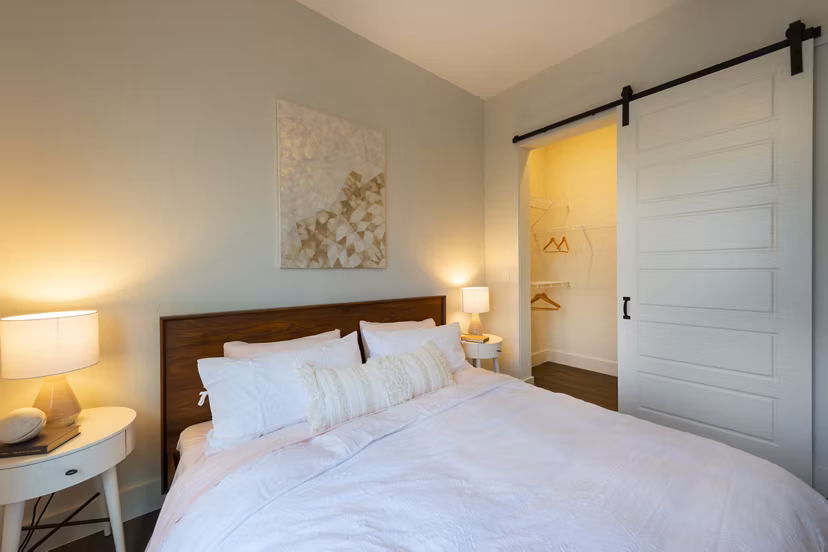 Bedroom with modern decor and large windows at Millennium Music Row Apartments, luxury living in Nashville
