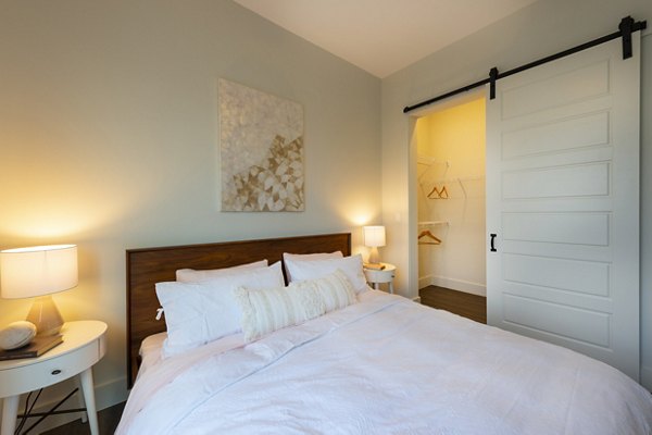 Bedroom with modern decor and large windows at Millennium Music Row Apartments, luxury living in Nashville